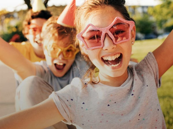 Group of young teenagers wearing star glasses outside