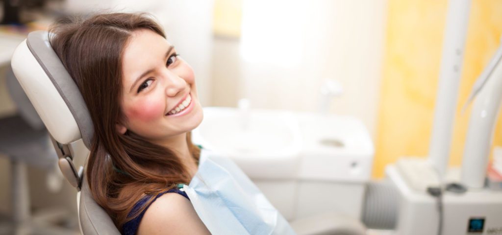 Girl at an orthodontist office learning about the Evolution of Braces
