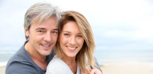 couple on the beach talks about Invisalign FAQs